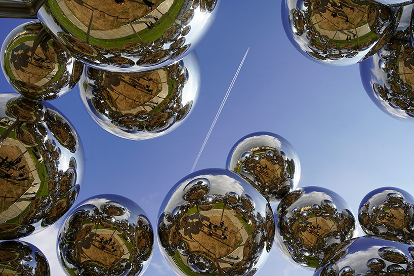 mirrored steel bubbles shape suspended kinetic sculpture by vincent leroy in normandy