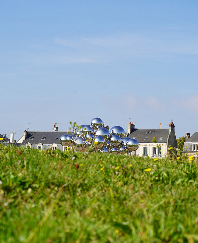 mirrored steel bubbles shape suspended kinetic sculpture by vincent leroy in normandy
