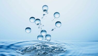 Water Droplets Splashing In Clear Blue Water