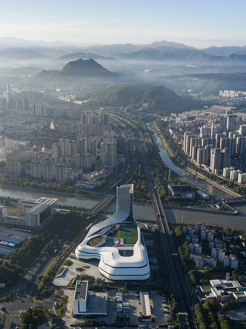 aluminum panels wrap landscape-inspired undulating facade of sports mall by line+
