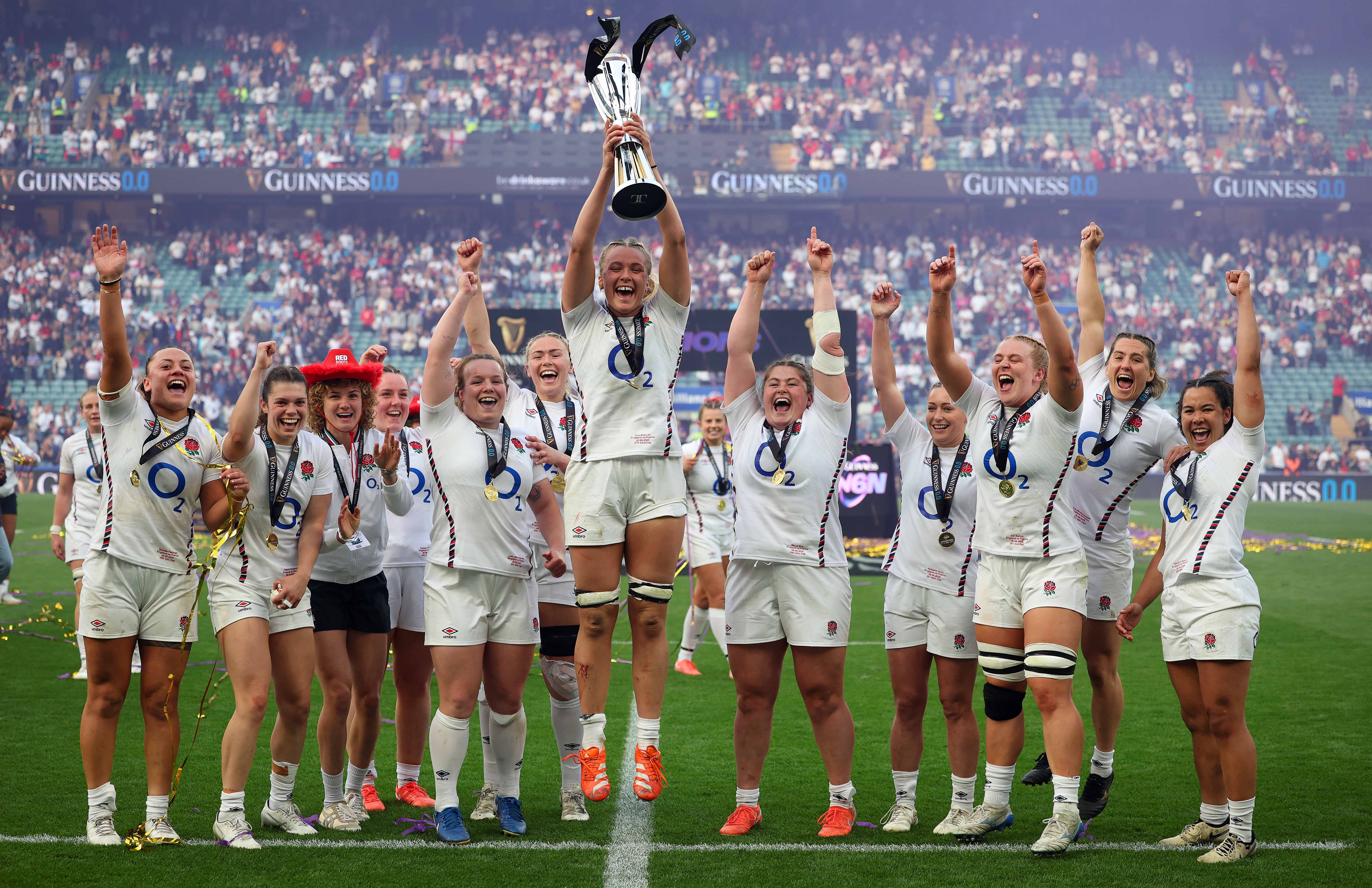 The England women's rugby team celebrates lifting the Women's Six Nations trophy after winning the Grand Slam.
