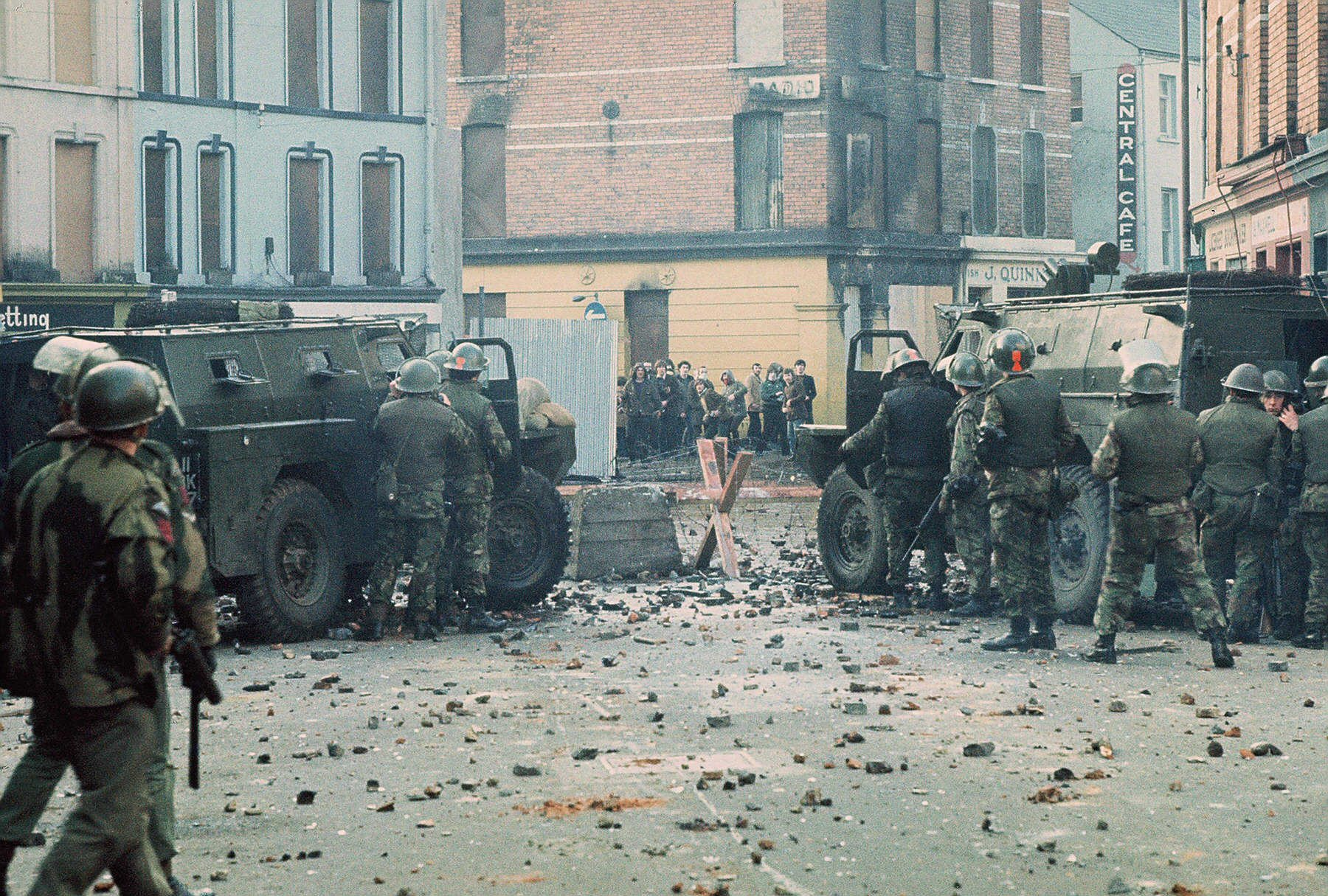 British soldiers with armored vehicles confront youths near a barricade on William Street in Derry/Londonderry, Northern Ireland.