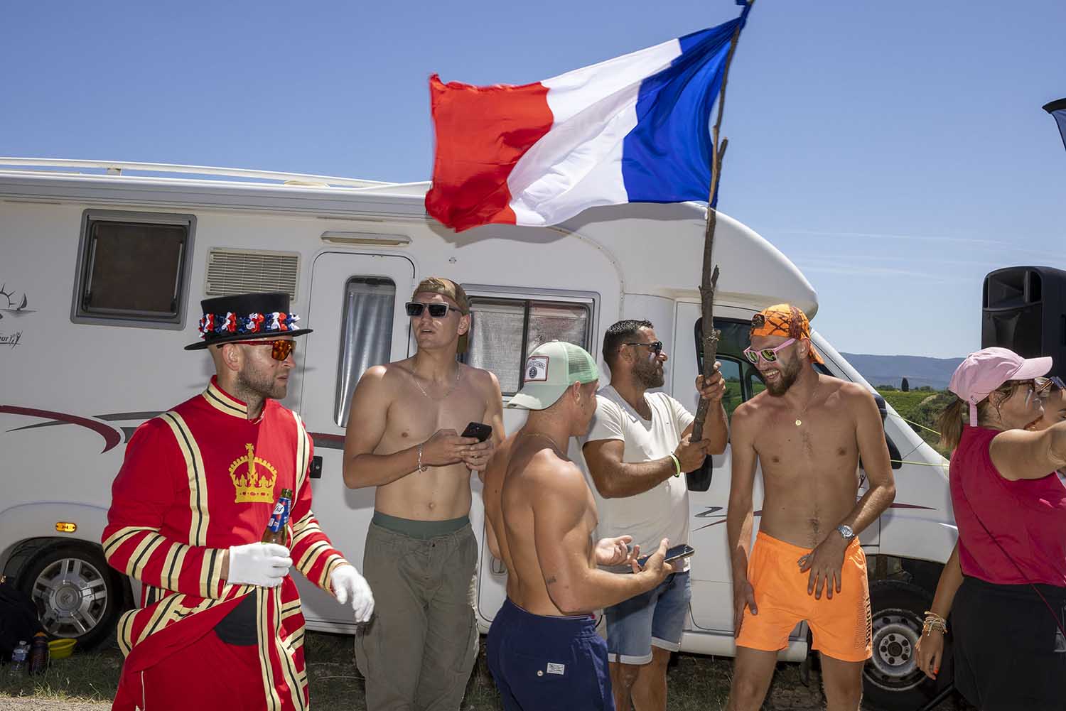 Fans, including one dressed as a Beefeater, gather with a French flag to watch the Tour de France on Mont Ventoux.