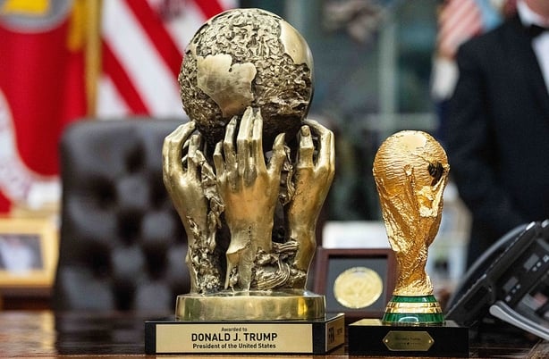 The (FIFA) Peace Prize, presented to US President Donald Trump at the 2025 World Cup Draw, left, displayed next to the FIFA World Club Cup Trophy 