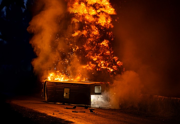 An orange fireball erupts from a minibus in a scene from Corriedale