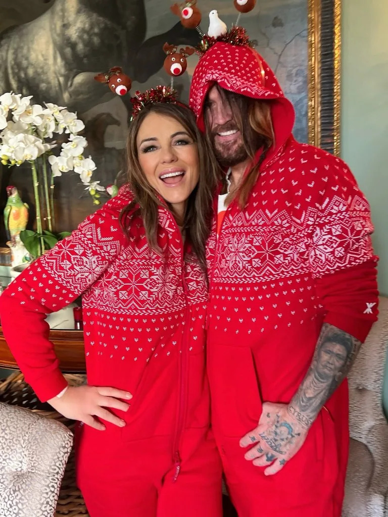 Billy Ray Cyrus and Elizabeth Hurley celebrated their first Christmas together as a couple in matching red onesie pajamas. Elizabeth Hurley/Instagram