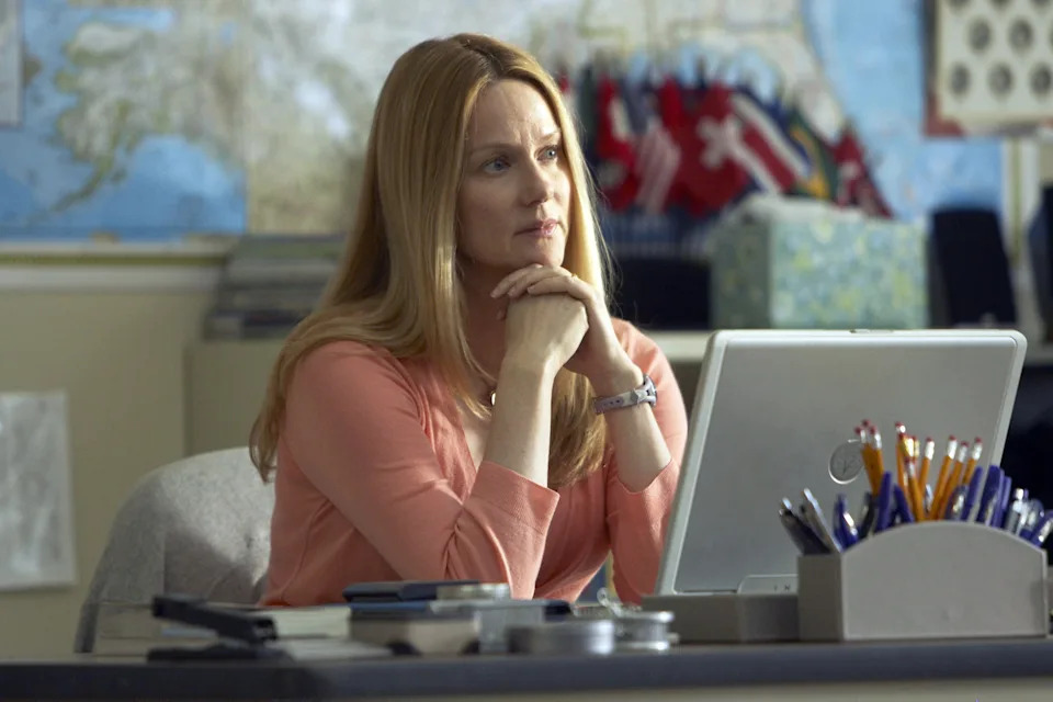 Laura Linney sitting at a work desk and resting her chin on her hands in The Big C.