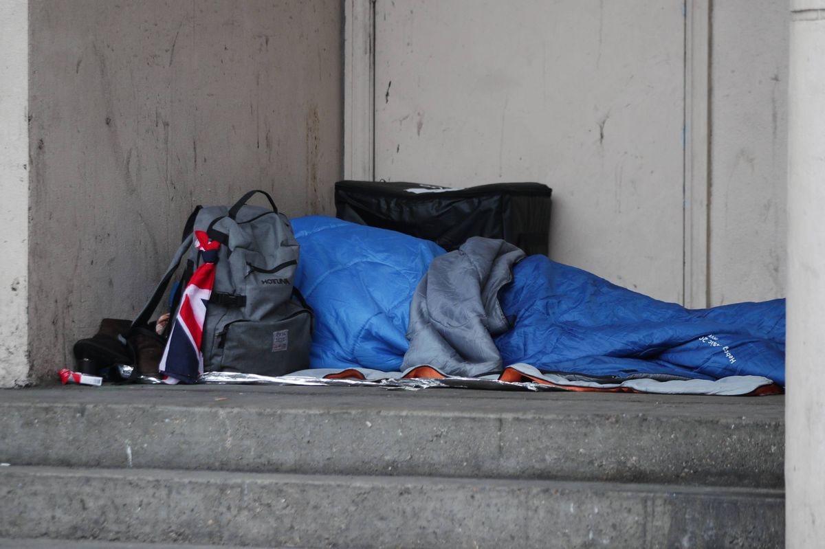 File photo of a homeless person sleeping rough in a doorway.