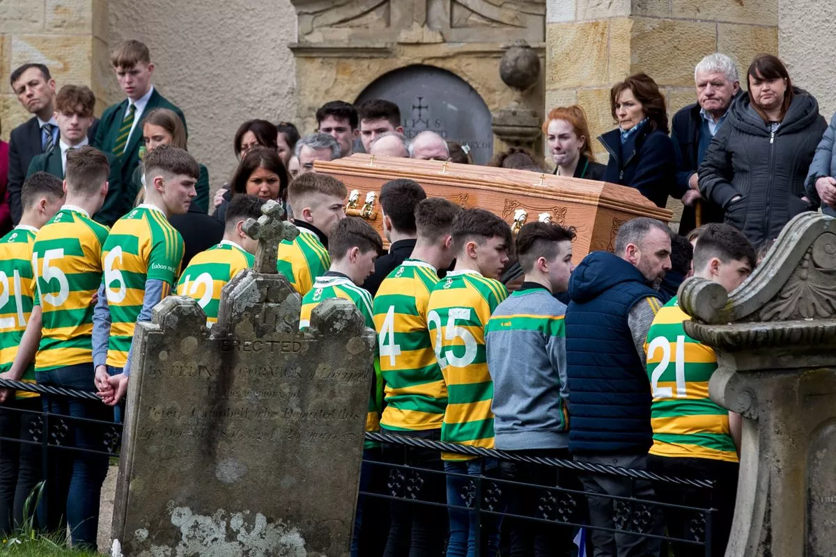 Members of the Edendork St Malachys football squad form a guard of honour to farewell teammate Connor Currie