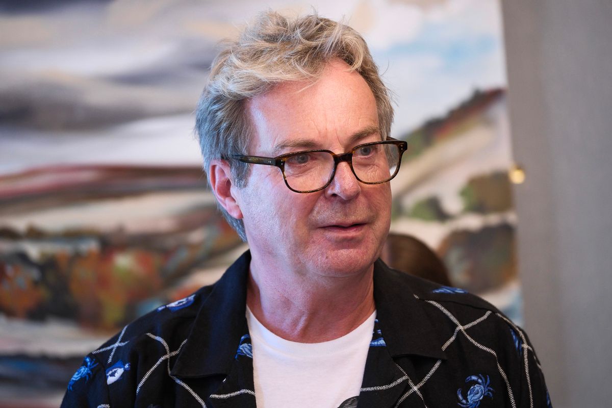 Julian Clary wearing glasses and a patterned shirt