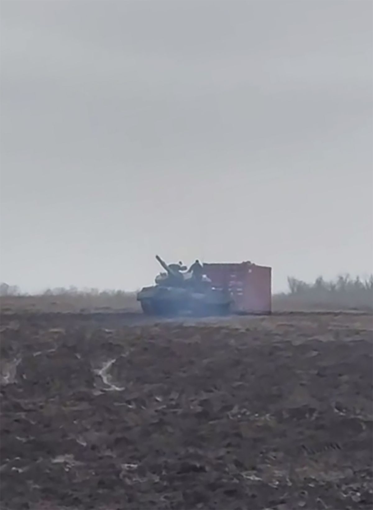 Footage shows a T-62 Russian tank dragging a sea container across a field for 'military purposes'