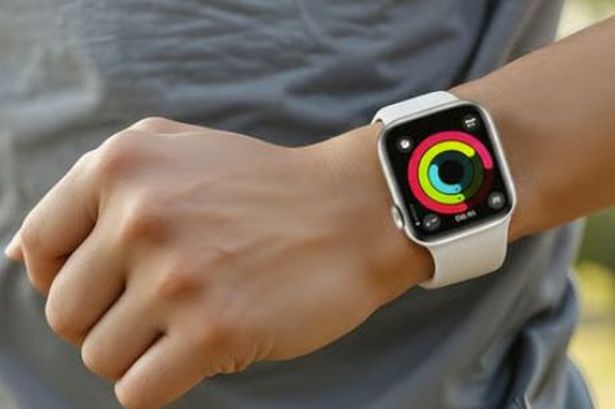 A person wearing the Apple Watch series 4 in silver