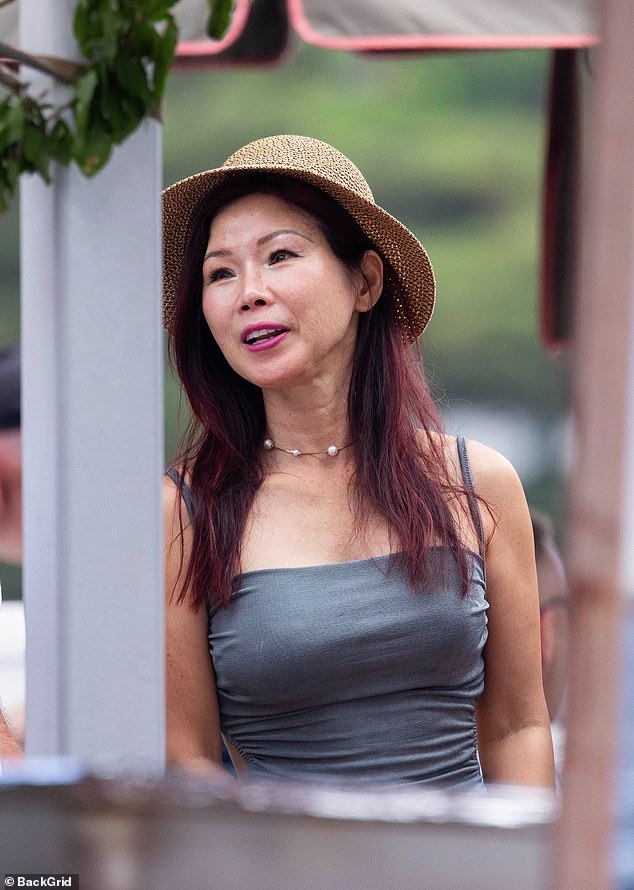 Sunny, 58, showed off her figure in a backless, tight dress as she arrived to the venue arm in arm with her man