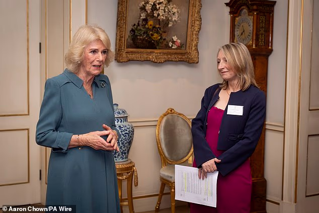 Queen Camilla with CEO of Surviving Economic Abuse Sam Smethers during a reception at Clarence House, London