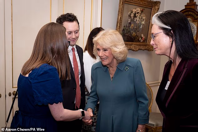 The Queen was wearing a teal dress alongside an enamel and diamond set brooch by Wartski
