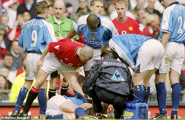 Roy Keane has reignited his long-standing feud with Erling Haaland's father Alf-Inge (pictured in 2001 when Keane clattered Haaland during the Manchester derby)