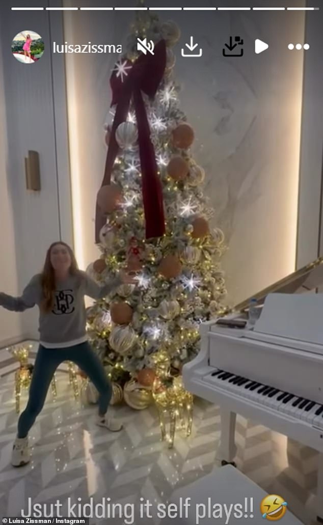 She posed by her huge Christmas tree and grand white piano in her new Dubai home