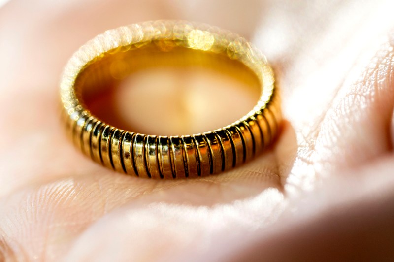 A closeup of a gold-toned ring in a hand palm.