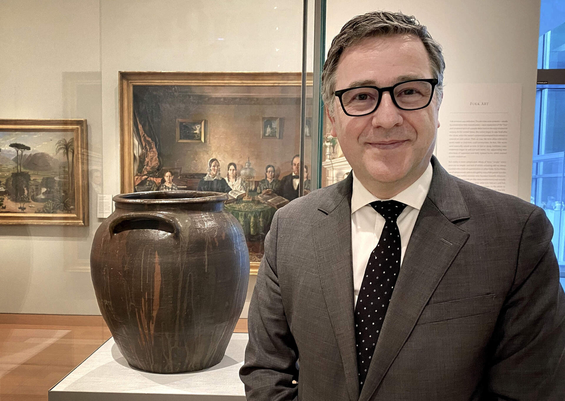 MFA director Pierre Terjanian standing next to a pot made by Dave Drake in the museum's Art of the Americas wing. (Andrea Shea/WBUR)