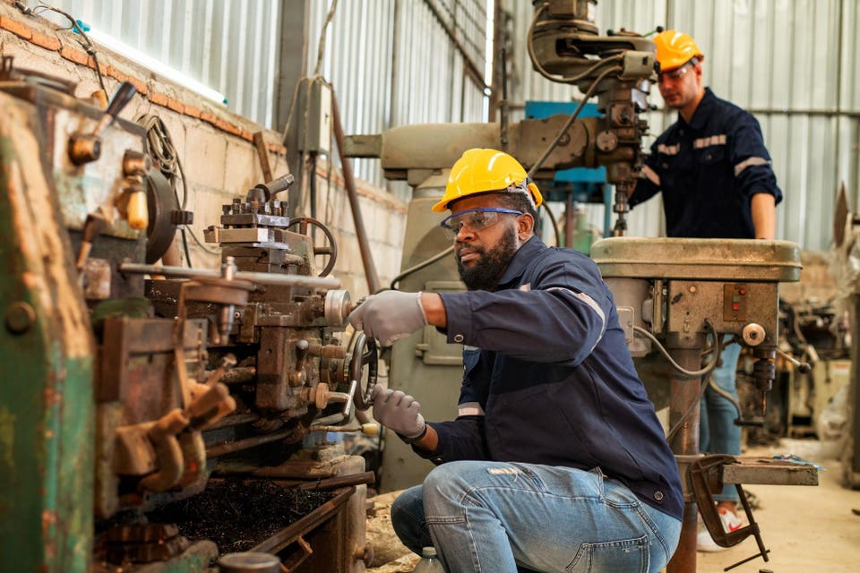 Engineer factory industry wearing safety uniform work and checking system of the welding robots for welding steel electrical by control system robot automate for industry manufacture concept.
