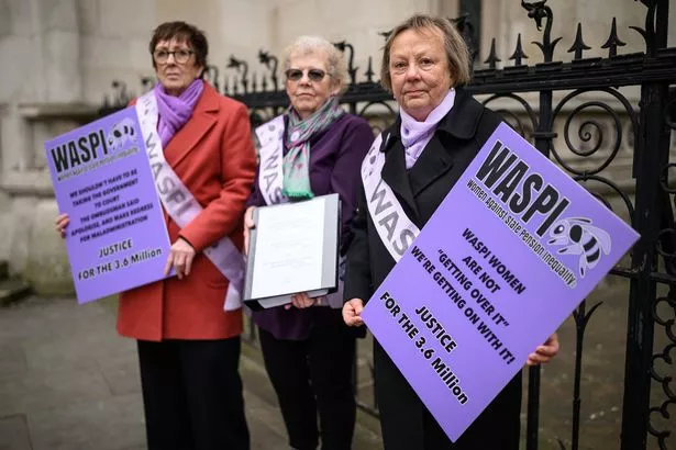 LONDON, ENGLAND - MARCH 17: A group of women representing the WASPI protest group stand outside the Royal Courts of Justice during a demonstration on March 17, 2025 in London, England. The Women Against State Pension Inequality (WASPI) organization is seeking a judicial review after the government said in December it would not pay out compensation, following a Parliamentary Ombudsman's report that found 1950s-born women were not properly informed about changes to state pension age and had suffered injustice.  (Photo by Leon Neal/Getty Images)
