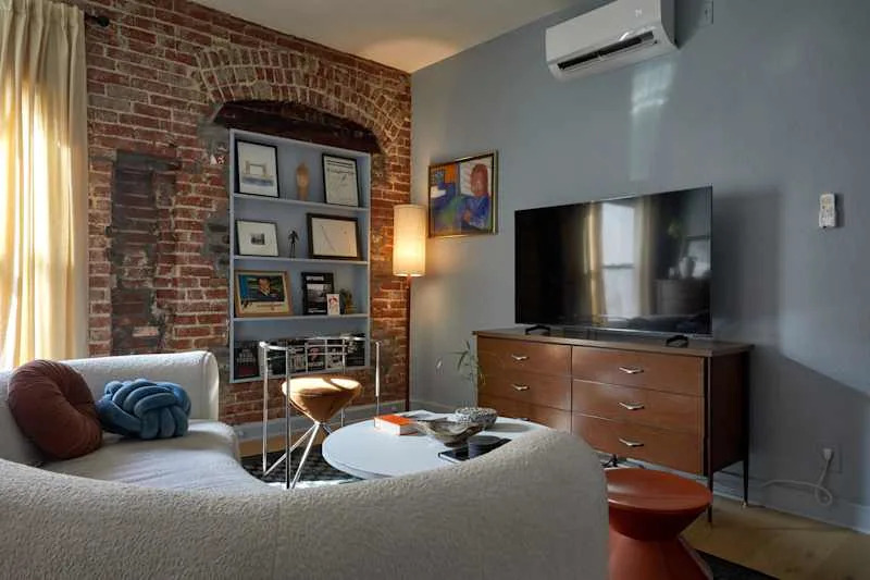 Gray living room space with exposed brick