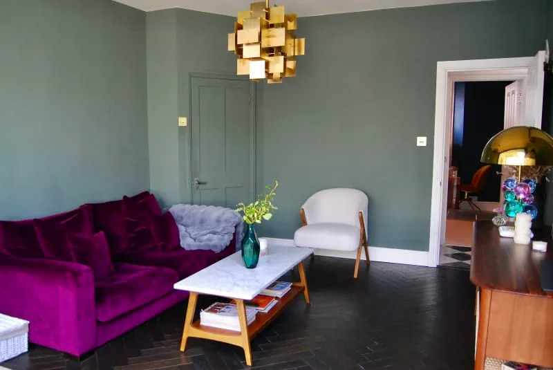 Living room with satin purple couch near a marble table