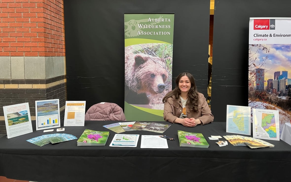 A woman sits at a table.