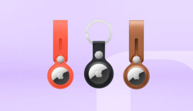 From left: bright orange, black and tan Apple AirTag keychains against lavender CNET background.