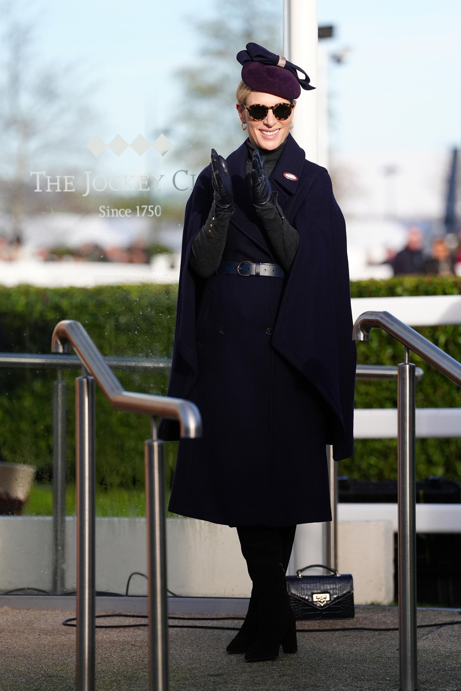 Image may contain Zara Tindall Clothing Coat Glove Overcoat Person Accessories Belt Adult Glasses Bag and Handbag