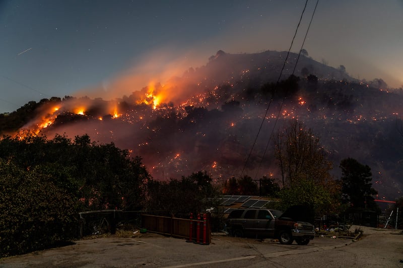 Fire rages through a hillside overlooking the Fernwood neighbourhood of Topanga, California, in January. Photograph: Kyle Grillot/The New York Times