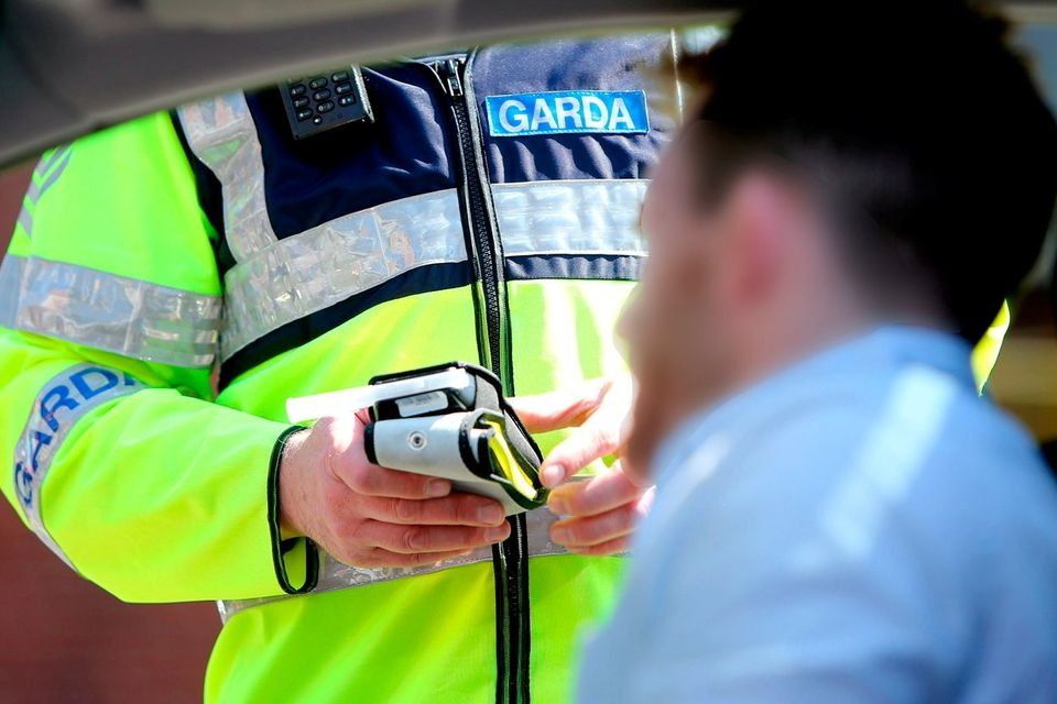 A stock image of a garda conducting a roadside breath test.