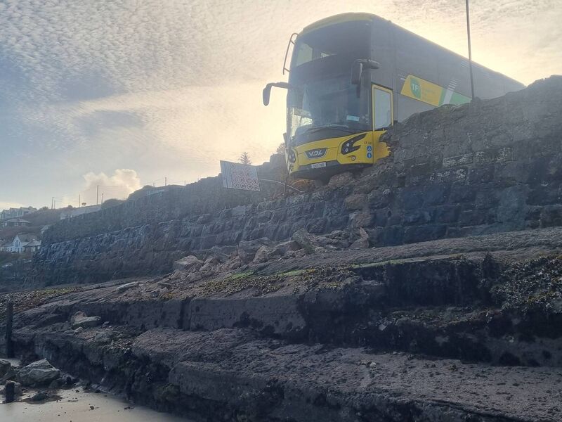 The bus was left protruding over a two-metre drop above the beach in Ardmore. Picture: Christy Parker