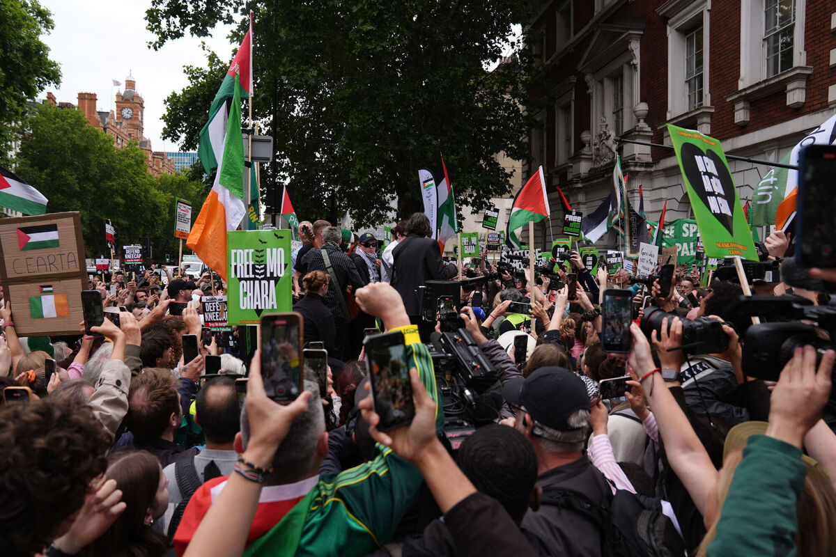 Kneecap's Liam Og O hAnnaidh (centre blue cap) leaves Westminster Magistrates' Court in London, last August where he was charged with a terrorism offence. File photo: Ben Whitley/PA