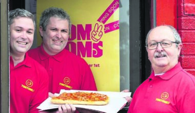 Cork chipper boss Tom hands over a pizza the action to his twins