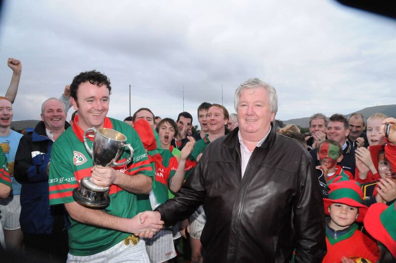 Donal O'Sullivan, then the Beara chairperson, presenting the Cormac O'Sullivan Cup to his namesake, Glengarriff captain Donal O'Sullivan, in 2009. 