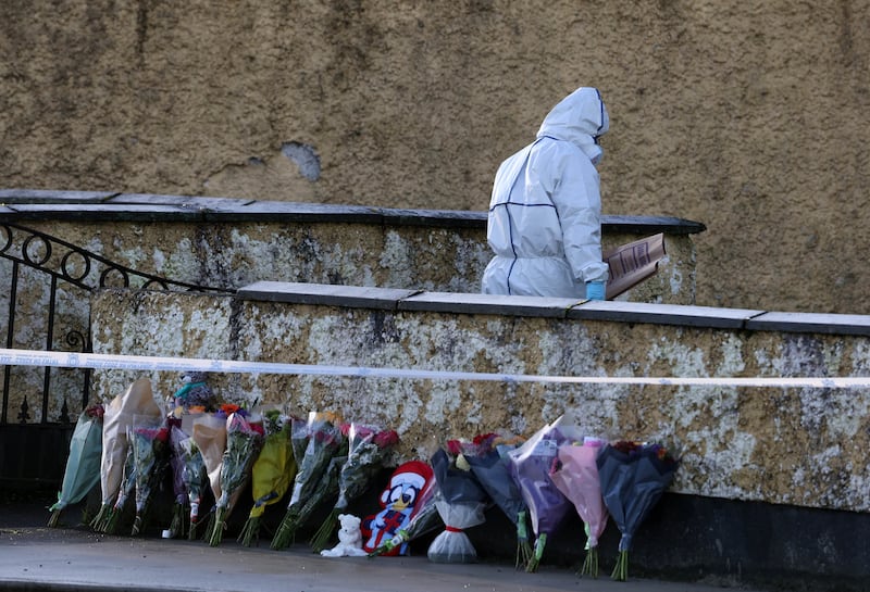 A member of the garda forensics teams enters the front garden of the house. Photograph: Colin Keegan/Collins