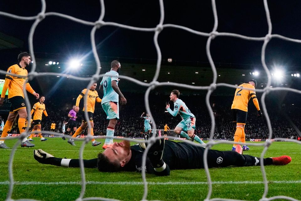 Brentford's Keane Lewis-Potter celebrates scoring their second goal as Wolverhampton Wanderers goalkeeper Jose Sa lies dejected during the Premier League match at Molineux Stadium