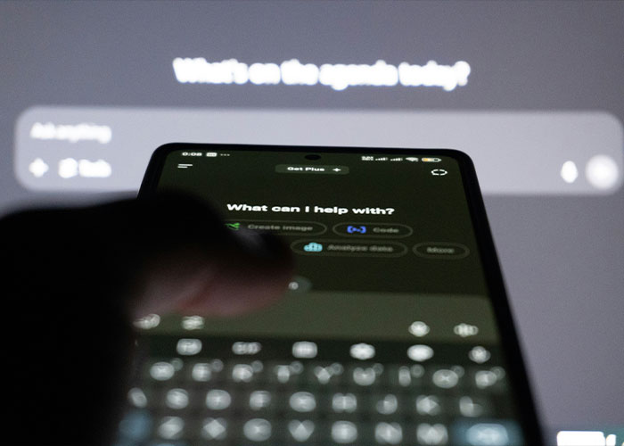 A close-up of a smartphone screen showing ChatGPT interface with a blurred keyboard and user interaction. A close-up of a smartphone screen showing ChatGPT interface with a blurred keyboard and user interaction.