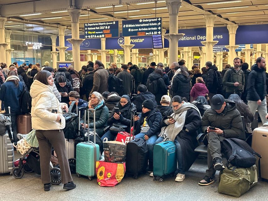 Delayed passengers at St Pancras train station, central London, yesterday. Photo: PA