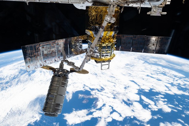 Northrop Grumman's Cygnus XL cargo craft is pictured in the grips of the International Space Station Canadarm2 robotic arm.