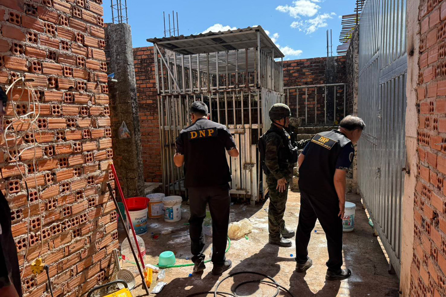 Thai wildlife officials inspect the area at the casino site, where they found five wild animals stranded in cages.