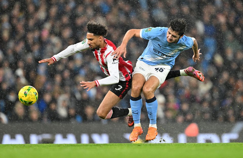 Brentford's Kevin Schade is bundled over by Manchester City's Abdukodir Khusanov