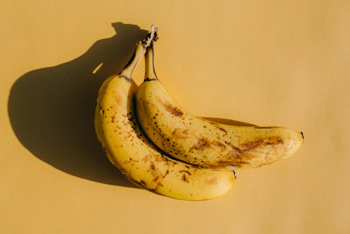 Two very ripe bananas, indicated by brown spots on the peel.