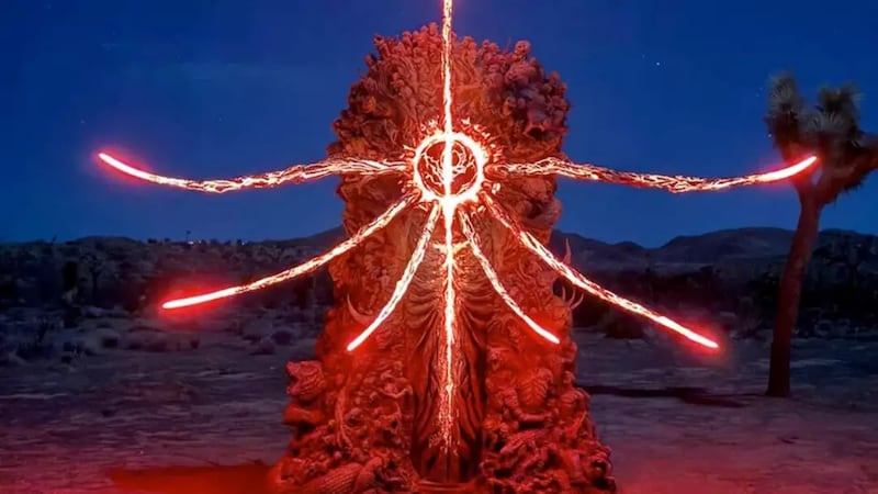 Figure with red lights coming out of it.