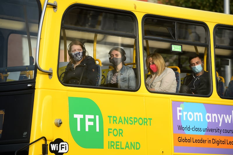 People wear face masks on a bus in DUblin during the pandemic. Photograph: Dara Mac Dónaill
