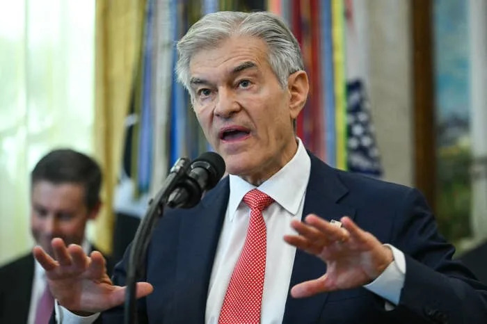 A person in a suit speaking passionately at a microphone during a formal event