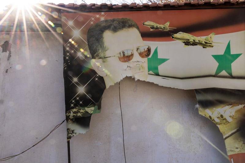 A torn portrait of the former Syrian president Bashar al-Assad, at the Mazzzeh Airbase in Damascus, Syria. Photograph: David Guttenfelder/The New York Times                     