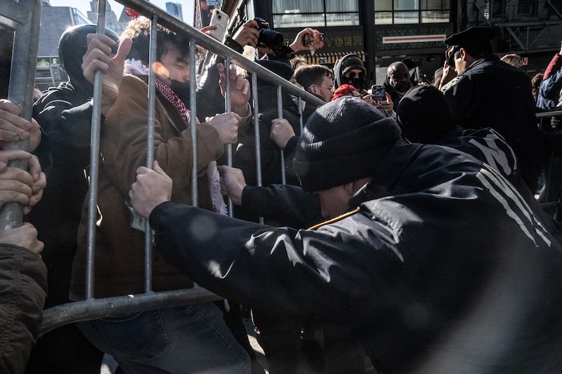 Immigration activists clash with NYPD officers as they block a garage used by Ice vans during a protest against a purported ICE raid on Canal Street on Saturday in New York City. Photograph: Stephanie Keith/Getty Images