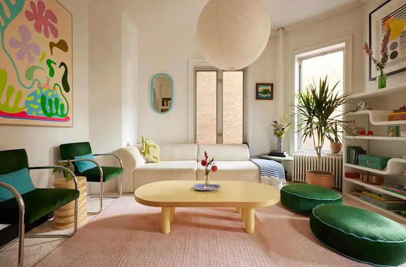 White living room space with colorful furniture